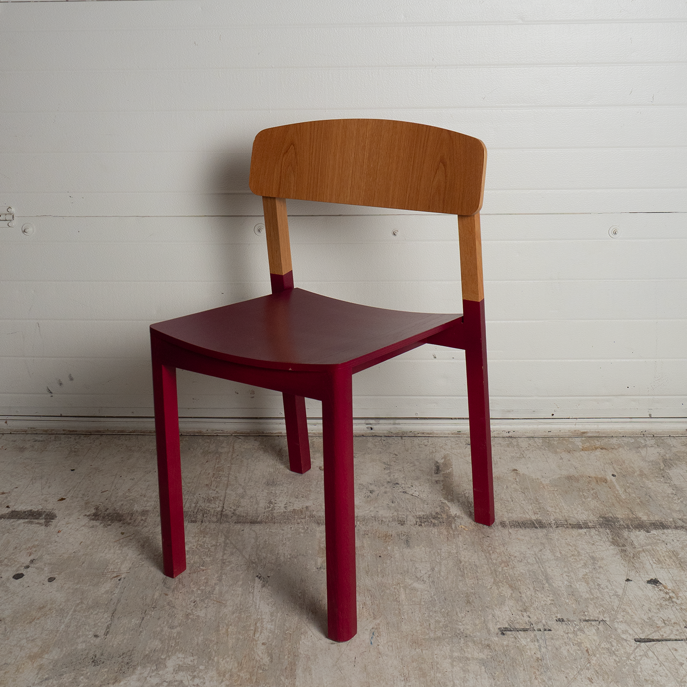 Dining chair with red legs and oak back rest