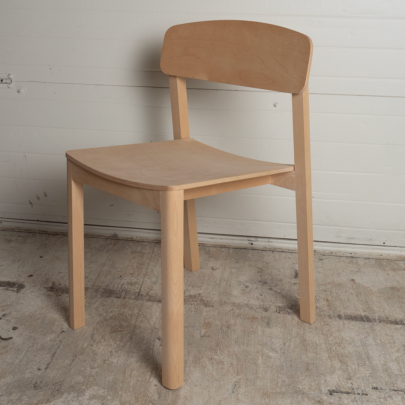 Wooden chair against a plain white wall